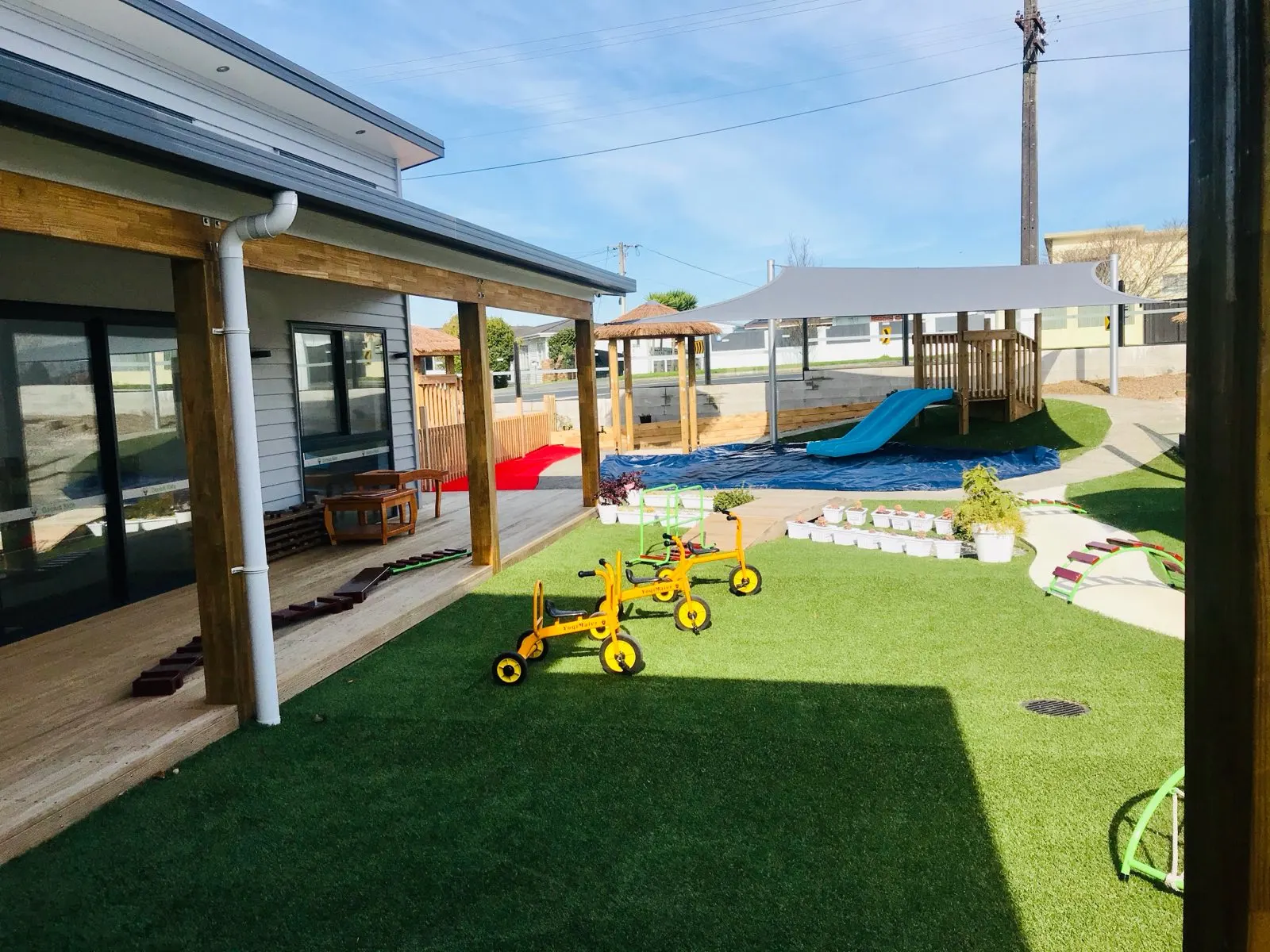 The garden with trikes, slide and covered verandah